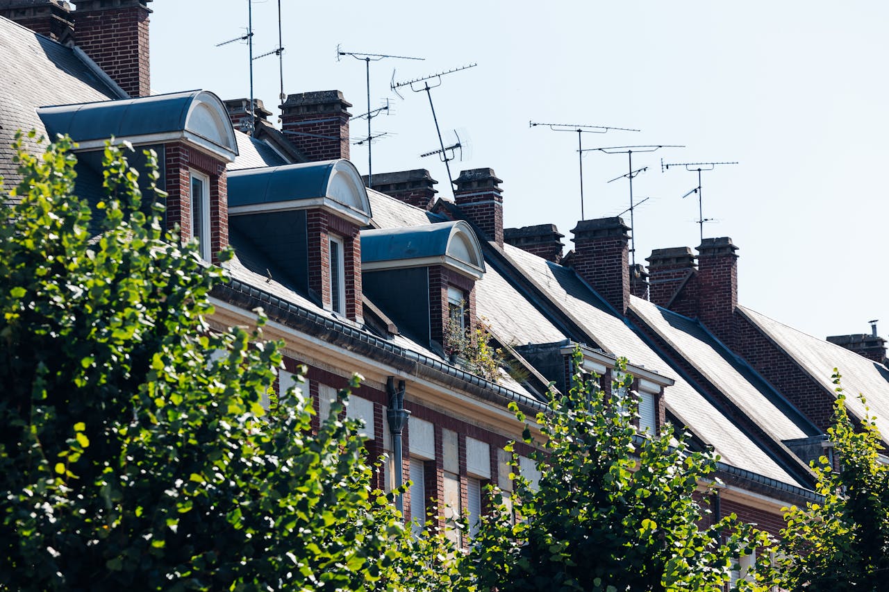 hero-img-01 Amiens Rooftops – Traditional Brick Houses with Chimneys and Antennas